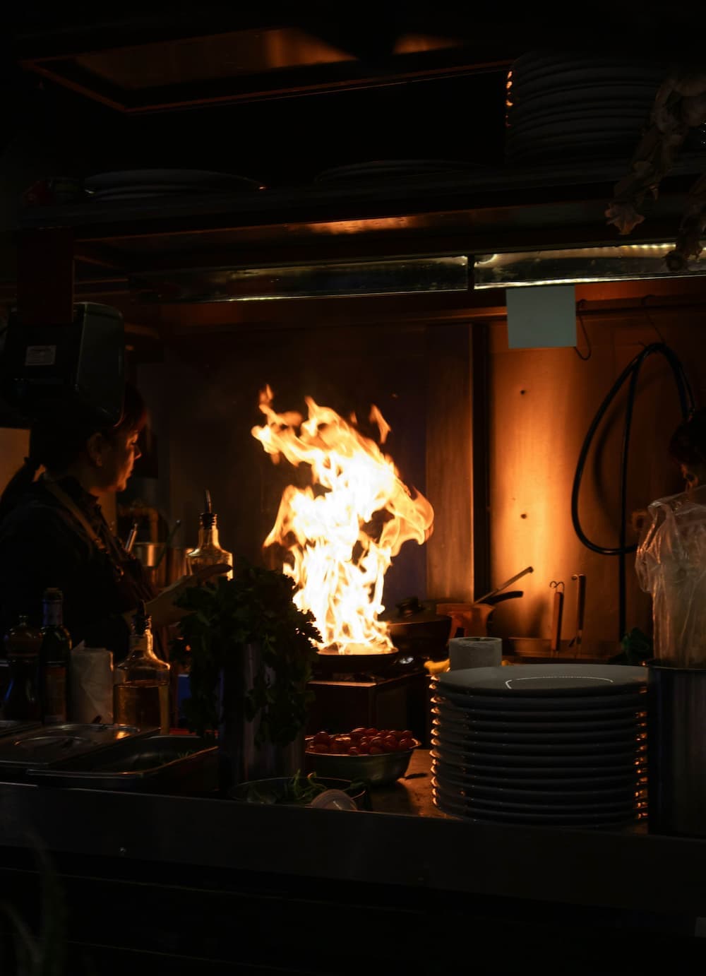 Chef cooking with flames in a pan